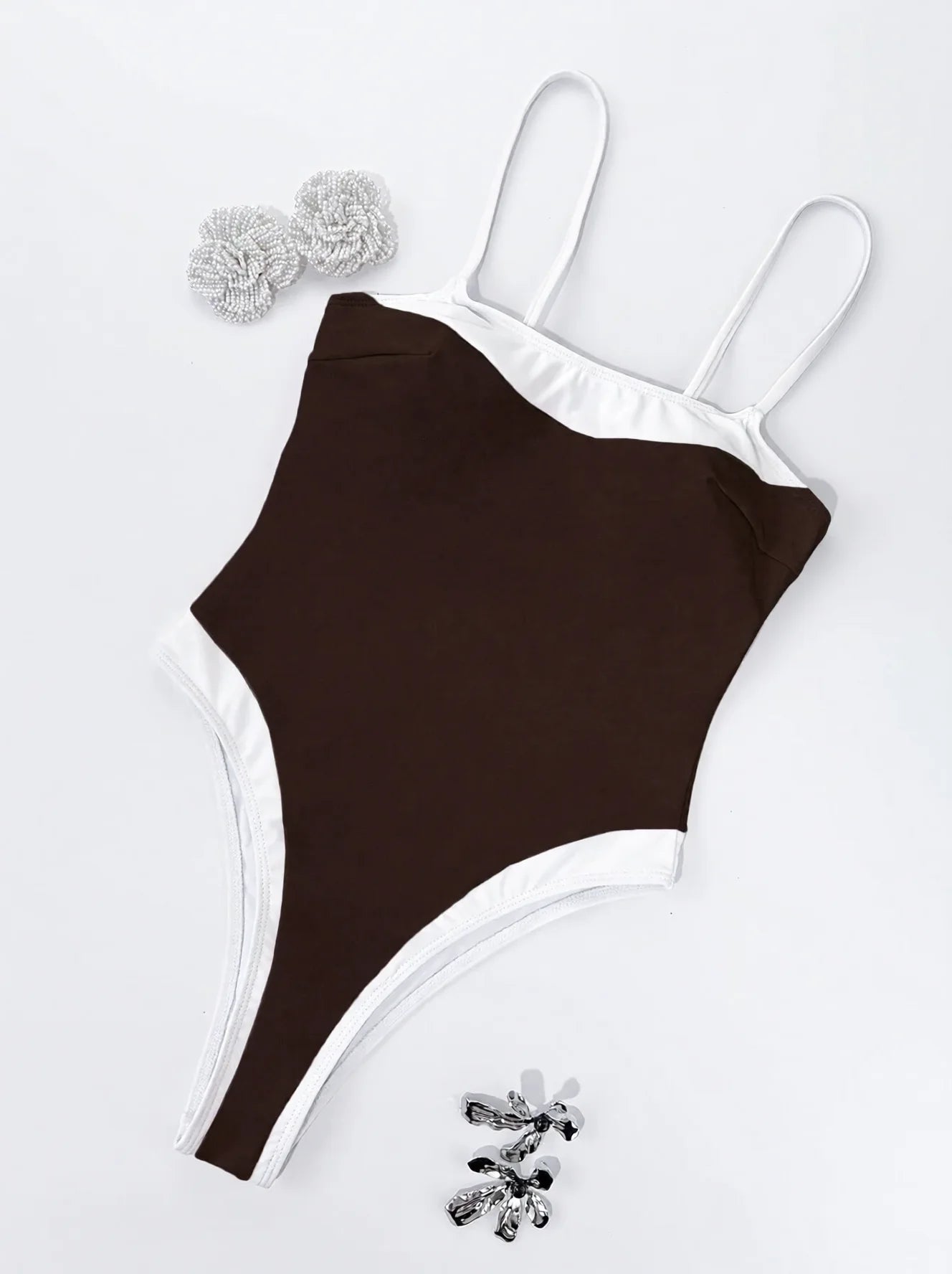 Brown one-piece swimsuit with white trim elegant beach vacation