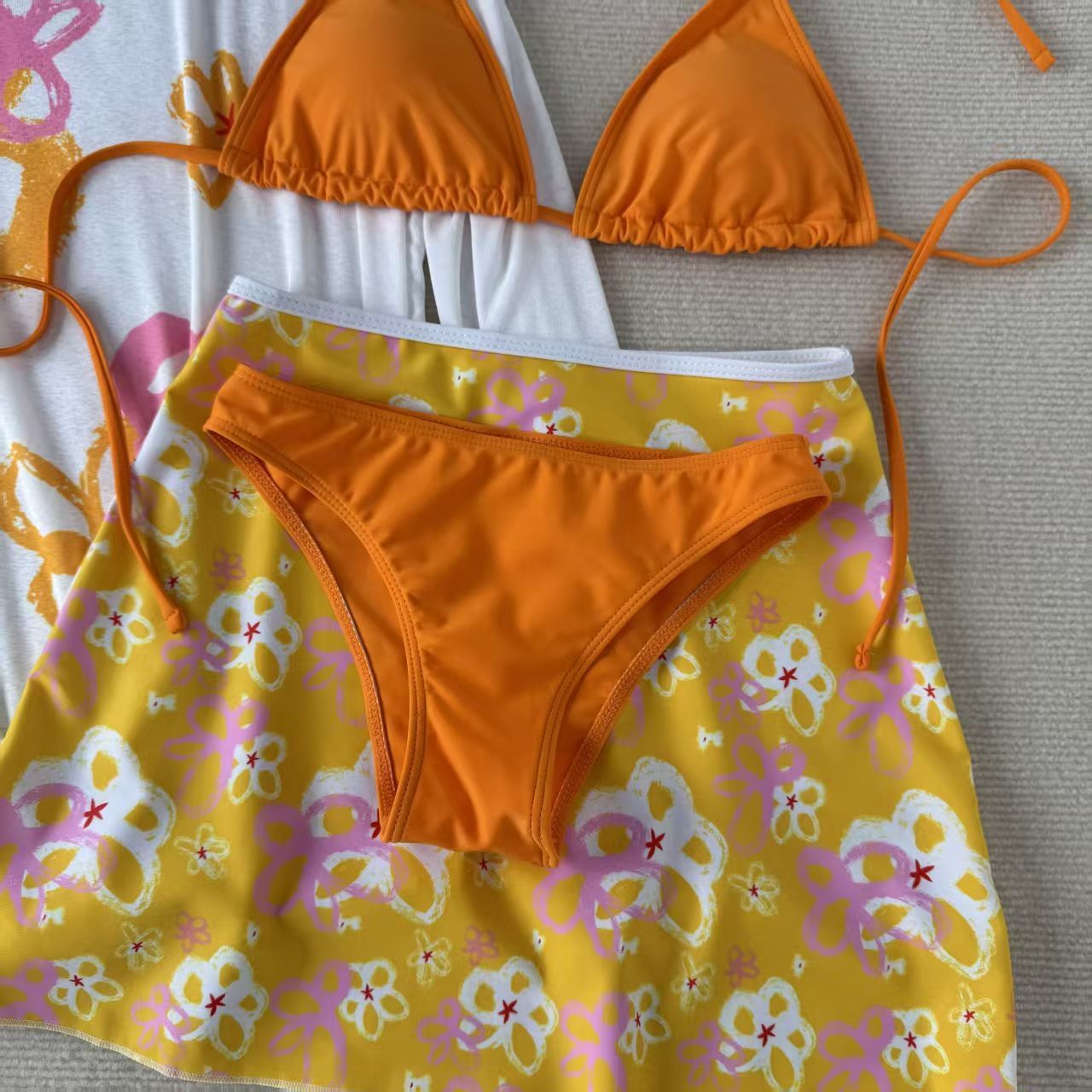 Three-piece orange bikini set with long-sleeve print cover-up