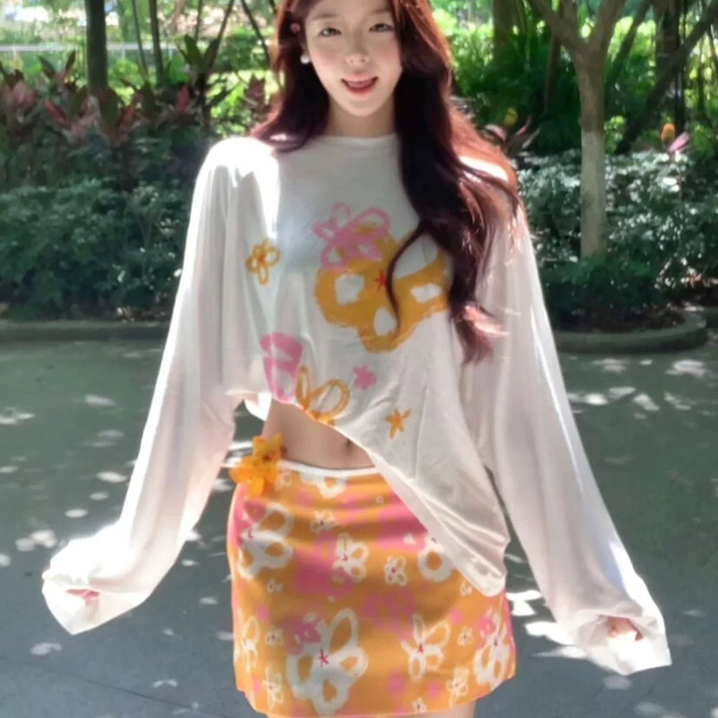 Three-piece orange bikini set with long-sleeve print cover-up