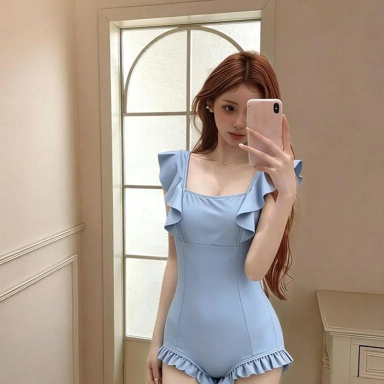 One-piece swimsuit with leaf trim, ruched waist and moderate coverage